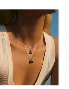 Detail view of double-layer S925 silver necklaces with blue enamel heart and round pendants
