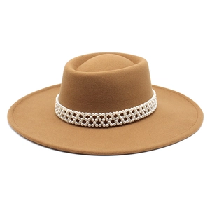 Detailed view of camel wool felt boater hat featuring triple-row pearl beaded embellishment