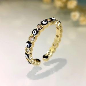 Detail of evil eye ring featuring gold plating and sparkling cubic zirconia stones