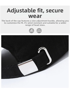 Close-up of black cotton baseball cap with adjustable silver metal buckle at the back
