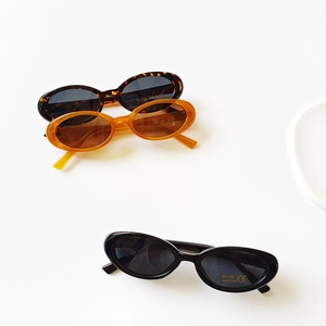Retro oval kids sunglasses with UV400 protection in leopard, amber, and black frames