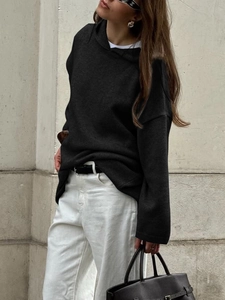 Close-up of black long-sleeved hooded sweatshirt with soft knit texture and loose fit