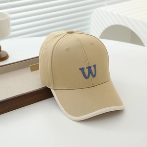 Detail of khaki cotton kids baseball cap with blue W embroidery and beige piping edge