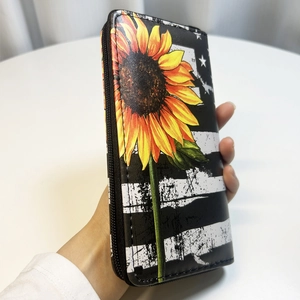 Macro detail of sunflower and American flag print on long PU leather zip wallet