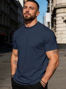 Close-up of a men's navy blue cotton T-shirt showing slim fit design and crew neck detail