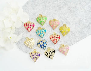Macro shot of 18K gold plated heart pendants with colorful enamel and micro-pave zircons