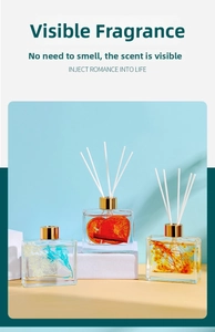 Close-up of glass reed diffuser bottle with dried orange slices and cinnamon sticks inside