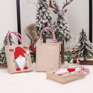 Christmas gnome burlap gift bags with striped handles for holiday candy and presents