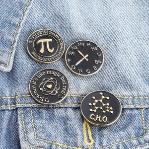 Set of 4 dark science enamel pins with gold formulas on denim jacket background