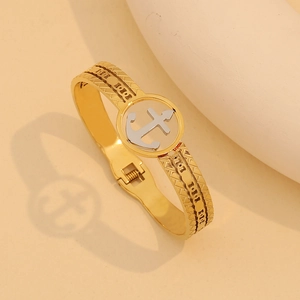 Dettaglio di un bracciale a cerniera bicolore con motivo ad ancora in un cerchio d'argento