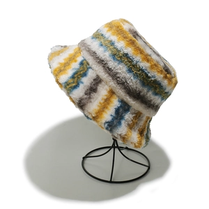 Close-up of colorful striped faux fur bucket hat with soft plush texture and wavy patterns