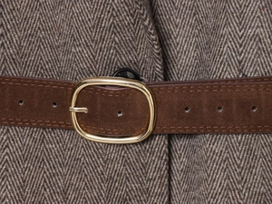 Close-up of brown herringbone blazer with a suede belt and gold oval metal buckle