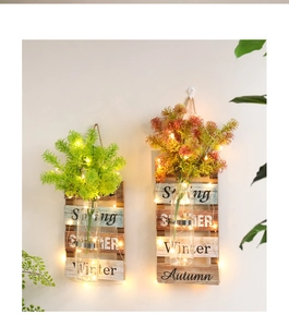 Decoración de pared de madera con jarrón de vidrio, luces LED y hojas de membrillo