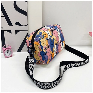 Close-up of cute rabbit prints and wide jacquard strap on a lightweight crossbody bag