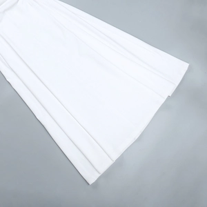 Detail view of the pleated white A-line dress showing fine fabric texture and fluid drape