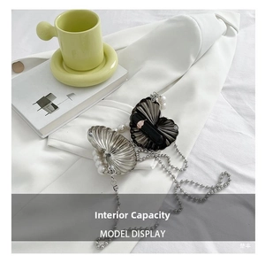 Macro view showing the interior capacity for one lipstick in a heart pearl clutch bag