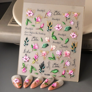Close-up of 5D floral nail stickers with pink flower patterns and embossed textures