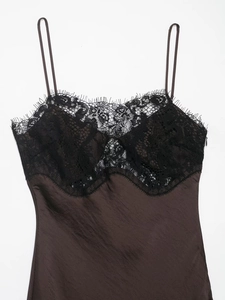 Close-up of brown satin slip dress featuring black eyelash lace trim and thin straps