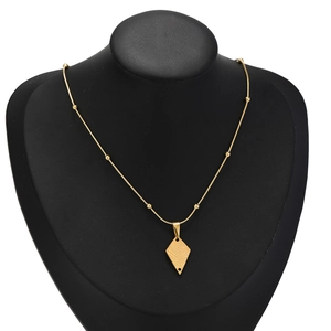 Golden stainless steel bead chain necklace with rhombus pendant on a black mannequin