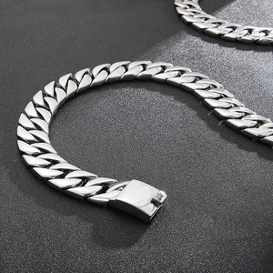 Close-up of polished silver stainless steel Cuban link chain with secure box clasp