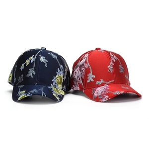 Ethnic floral embroidered baseball caps in navy blue and red cotton with vivid patterns