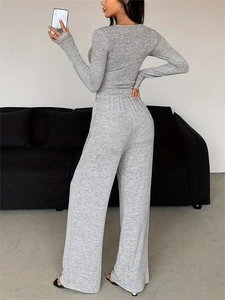 Detailed back view of a grey knitted lounge set featuring long sleeves and wide-leg trousers