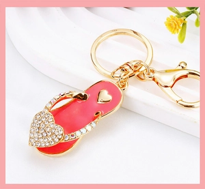 Close-up of pink rhinestone heart flip-flop keychain with gold-plated lobster clasp