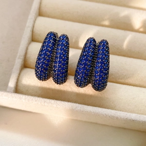Detailed close-up of vintage double-row zircon drop earrings in dark blue and gunmetal