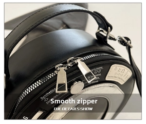 Detailed macro view of the smooth dual-zipper and handle on a creative washing machine bag