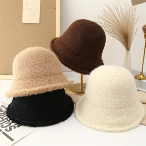 Detailed plush texture of winter knit bucket hats in beige, brown, and black tones