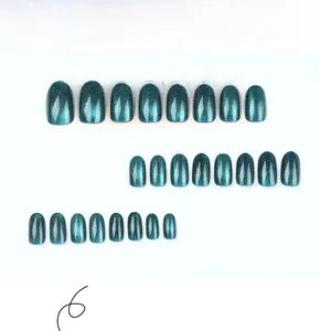 Detail view of 24 pieces of deep blue cat-eye press-on nails in a natural round shape