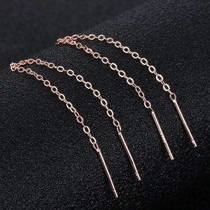 Detailed macro shot of two pairs of rose gold S925 silver long tassel chain earrings