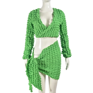Detailed view of neon green smocked popcorn fabric texture on two-piece skirt set