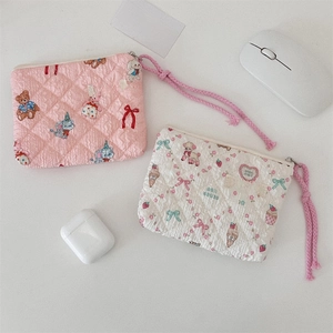 Close-up of floral quilted pouches showing delicate stitching and cute animal patterns