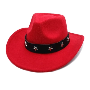 Close-up of red felt cowboy hat with black band and silver star metal ornaments