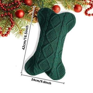 Detailed knit pattern on a dark green bone-shaped Christmas stocking for pet gifts
