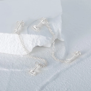 Detailed macro view of S925 sterling silver earring chain with clear 925 hallmarks