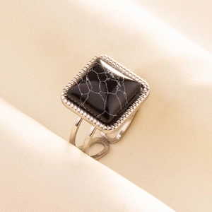 Macro view of vintage 304 stainless steel ring with square black marble stone and open band
