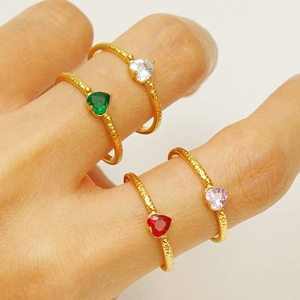 Macro shot of 18K gold plated heart zircon rings with textured hammered band details