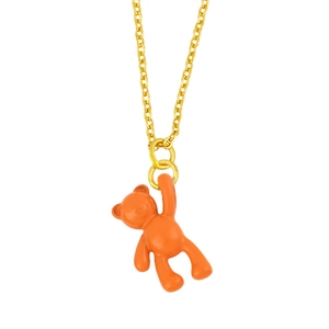 Detailed shot of an orange bear pendant on a minimalist gold chain with enamel finish