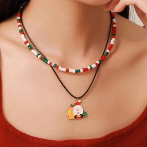 Detail of Christmas beaded necklace featuring Santa Claus pendant and festive colors