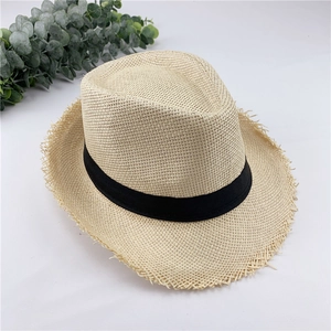Detail shot of breathable straw fedora hat with black ribbon and frayed edges