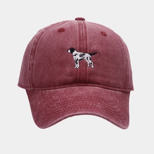 Close-up of vintage burgundy washed cotton baseball cap featuring dog embroidery detail