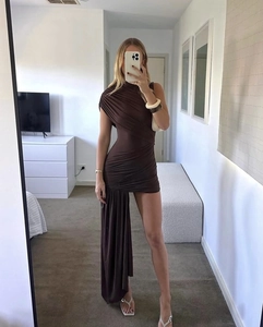 Detail of dark brown ruched mini dress featuring asymmetrical hem and elegant side drape
