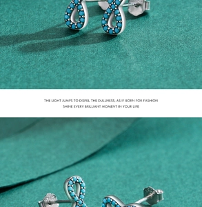 Detail of S925 sterling silver infinity earrings set with turquoise stones
