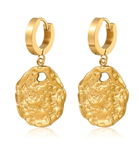 Detailed view of gold circular earrings with irregular textured finish on white background