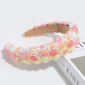 Detailed macro view of colorful fabric roses and lace mesh on a stylish headband