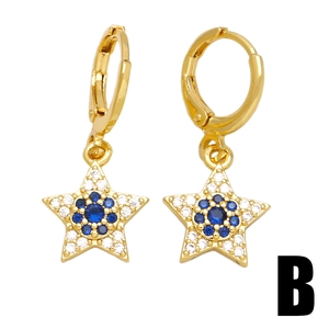 Vintage gold star earrings with blue crystals and white zircons in a symmetric view