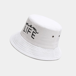 Detail of mom LIFE embroidery on white cotton bucket hat with metal air eyelets