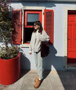 Outdoor street style view of cozy grey knit cardigan paired with a burgundy tote bag